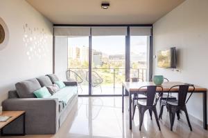 a living room with a couch and a table at Kóor Stays - Australis in Ushuaia