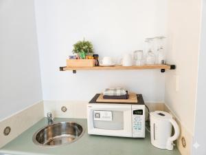 a kitchen with a sink and a microwave at Cozy water side apartment - Jetty in Mandurah +7 photos