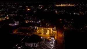 an aerial view of a city at night with lights at Trev Hotels and Suites in Asaba