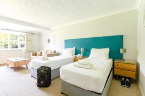 a hotel room with two beds and a couch at Thorpeness Golf Club and Hotel in Thorpeness +56 photos