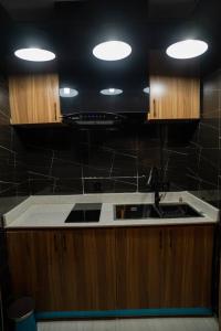 a kitchen with a sink and a counter top at Trev Hotels and Suites in Asaba