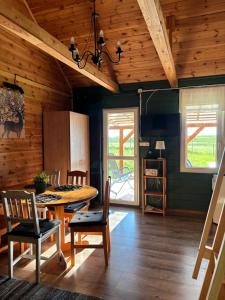 a dining room with a table and chairs at Leśny Zakątek - Mazury - Warmia - jezioro Dadaj in Ramsowo