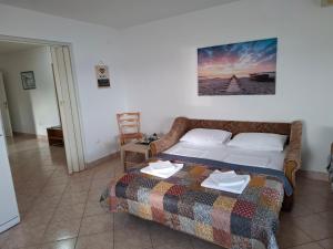 a bedroom with a bed with a blanket on it at Apartments 3 Palms in Crikvenica