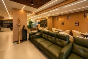 a living room with a couch and a table at Sabu's Grand Royale - Thampanoor in Trivandrum