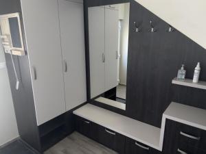 a bathroom with a sink and a mirror at Lenti Central Apartman in Lenti +15 photos