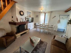 a living room with a couch and a table at Maison Vexin in Boury-en-Vexin