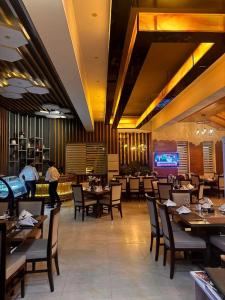 a dining room with tables and chairs in a restaurant at Stillers Residency in Rahimyar Khan