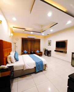 a hotel room with a bed and a flat screen tv at Stillers Residency in Rahimyar Khan +19 photos