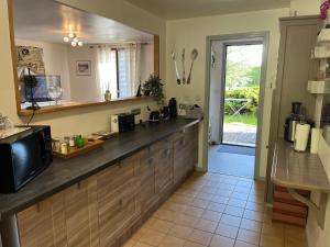 a kitchen with a counter top and a sink at Maison Vexin in Boury-en-Vexin +4 photos