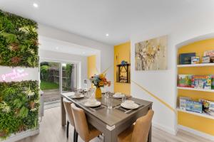 a dining room with a table and chairs at Modern House, Pool Table, Parking & Garden in Fallings Park