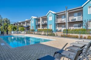 a swimming pool in front of a apartment complex at Cozy water side apartment - Jetty in Mandurah