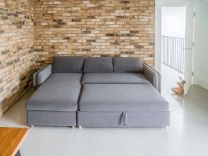 a couch in a living room with a brick wall at Glenvar in Falmer +39 photos