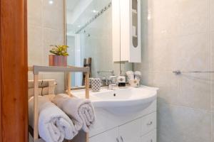 a white bathroom with a sink and a mirror at By Domy 2 Grottaglie in Grottaglie +19 photos