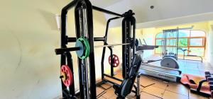 a gym with two tread machines in a room at Diani White Sands in Diani Beach