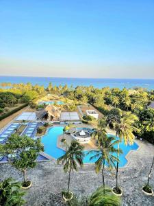 an aerial view of a resort with palm trees and the ocean at Diani White Sands in Diani Beach