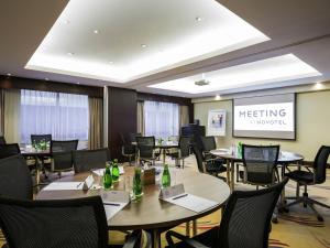 a meeting room with tables and chairs with bottles on them at Novotel Deira Creekside Dubai in Dubai +151 photos
