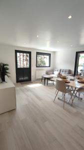 a large room with tables and chairs and a couch at La petite maison de la Drôme in Aouste-sur-Sye