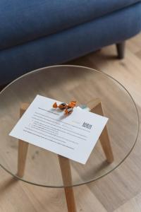 a glass table with a piece of paper on top of it at BRIT HOTEL Le Lion d'Or CHINON in Chinon