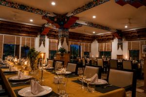 a dining room with a long table and chairs at The Apricot Tree Hotel in Nūrla +4 photos