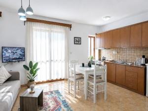a kitchen and living room with a table and chairs at Vangert Apartment in Berat