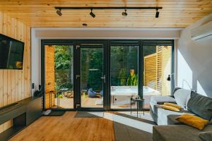 a living room with a couch and sliding glass doors at Golden Wood in Sovata