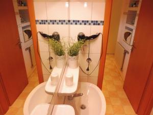 a bathroom with two vases on a sink at Ferienwohnung Graf Strandgut in Karlshagen