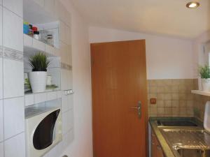 a kitchen with a brown door and a sink at Ferienwohnung Graf Strandgut in Karlshagen