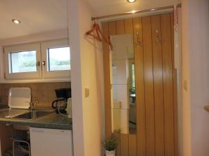 a kitchen with a door leading into a kitchen with a sink at Ferienwohnung Graf Strandgut in Karlshagen