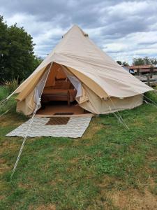 a large tent sitting on the grass in a field at The Old Waterworks - Venus Bell Tent in Clare