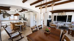 a kitchen and living room with a table and chairs at Bellapais Stone Villa in Kyrenia