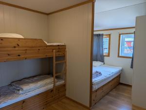 a bedroom with two bunk beds and a mirror at Solstrand Camping in Vigeland