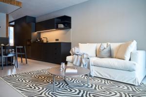 a living room with a white couch and a table at Aparthotel Chalina by Peak Stay in Leutasch