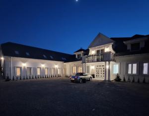 a car parked in front of a house at night at Tesao Room by Dworek Marino in Grzybowo