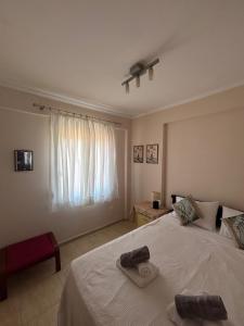 a bedroom with a bed with two towels on it at Danai Nefeli Apartment in Siviri