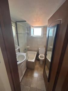 a bathroom with a tub and a toilet and a sink at Danai Nefeli Apartment in Siviri +53 photos