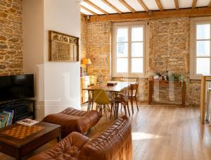 a living room with a couch and a table at Le Cocon de la Presqu'île in Lyon