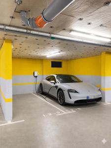a white car is parked in a garage at Tiffany Delux in Banja Luka