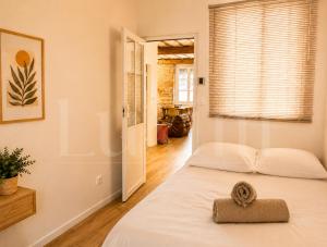 a bedroom with a bed with a towel on it at Le Cocon de la Presqu'île in Lyon