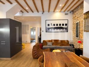 a living room with a couch and a table at Le Cocon de la Presqu'île in Lyon