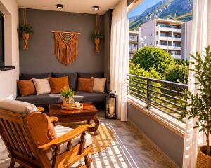 a balcony with a couch and a table at Johanan in Makarska