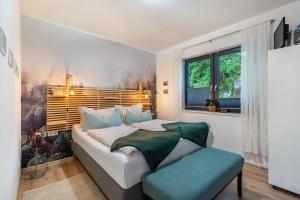 a bedroom with a large bed and a window at Schmidtsches Quartier in Oybin
