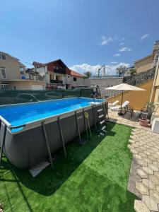 a swimming pool in a yard with grass at House 23 A2 in Tivat
