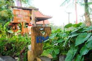 a sign in front of a building with plants at Rise Simpangan Villa in Payangan