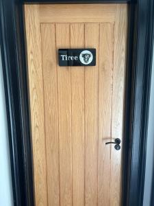 a wooden door with aire sign on it at Strathmore Guest house in Fort William