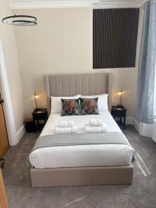 a bedroom with a large bed with towels on it at Strathmore Guest house in Fort William