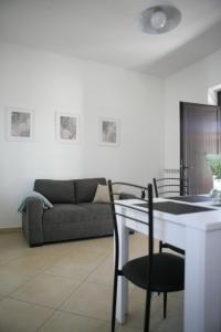 a living room with a table and a couch at Casa di Nonna Angela in Guadamello