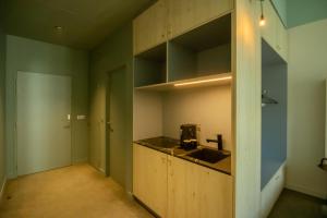 a kitchen with a sink and a counter top at Ysotop Hôtel Grenoble in Grenoble +20 photos