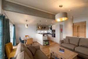a living room with a couch and a table at Lost Shore Surf Resort in Ratho +33 photos