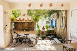 a bike parked in the entrance to a house at Marilia GuestHouse - Seaside Retreat in Evia in Agia Anna