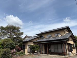 a japanese house with a black roof at 民泊ａｉｋｏ in Fukushima